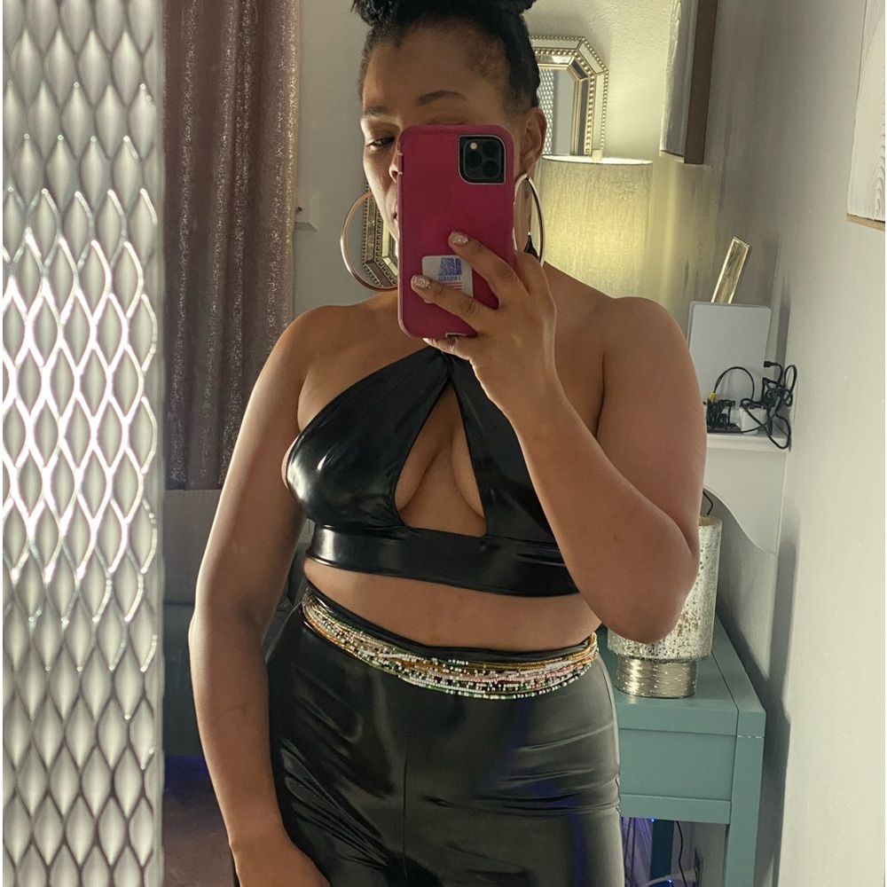 An elegant black faux leather two-piece pant set is a wise choice. A must have.